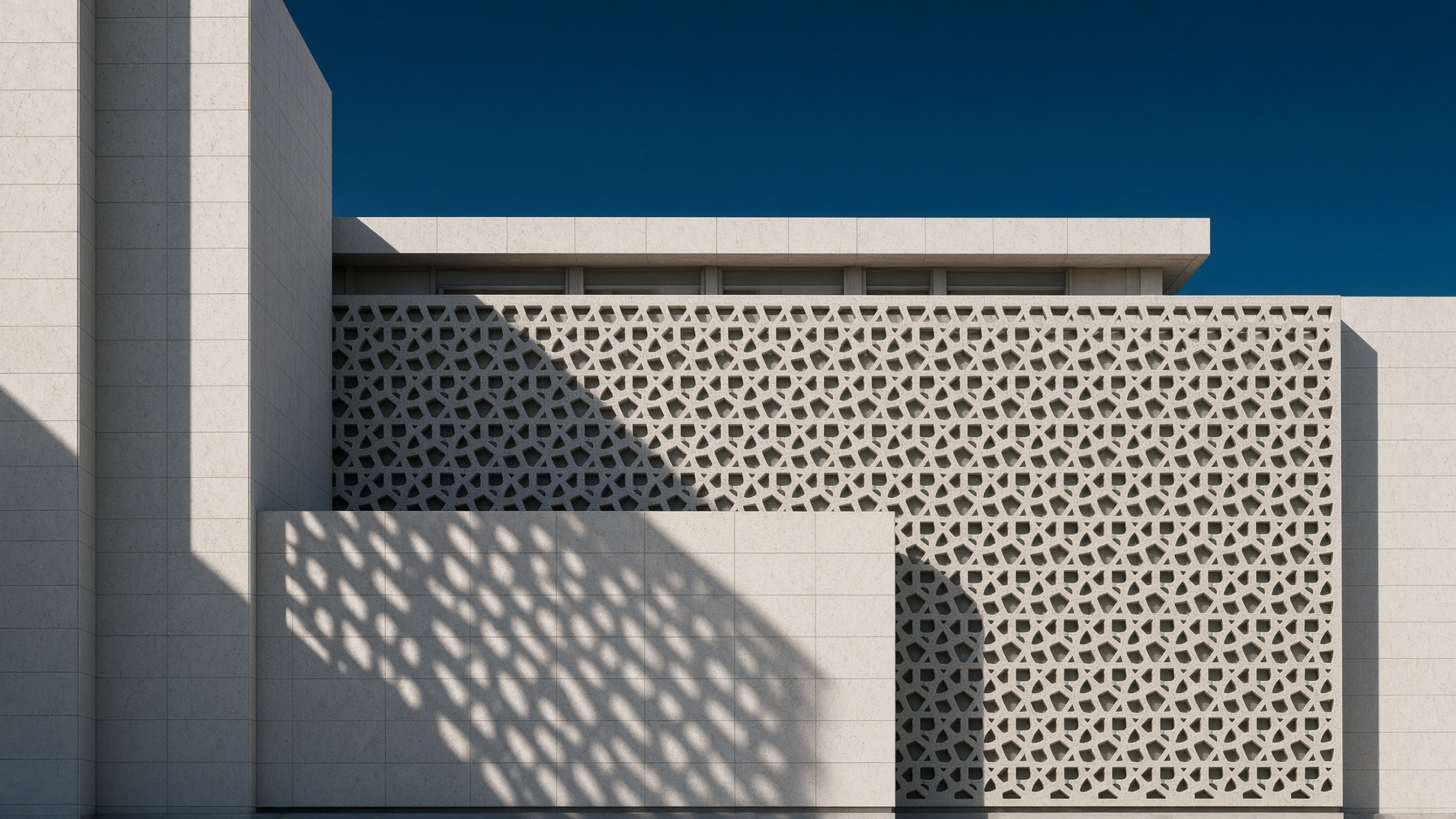 Limestone facade with geometric mashrabiya screen